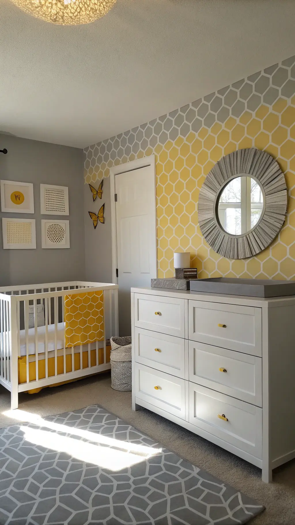 A modern nursery with a gray and yellow color scheme featuring honeycomb wallpaper, a white crib with geometric bedding, and a sleek gray dresser with brass hardware, styled with minimalist bee artwork and metallic accents.