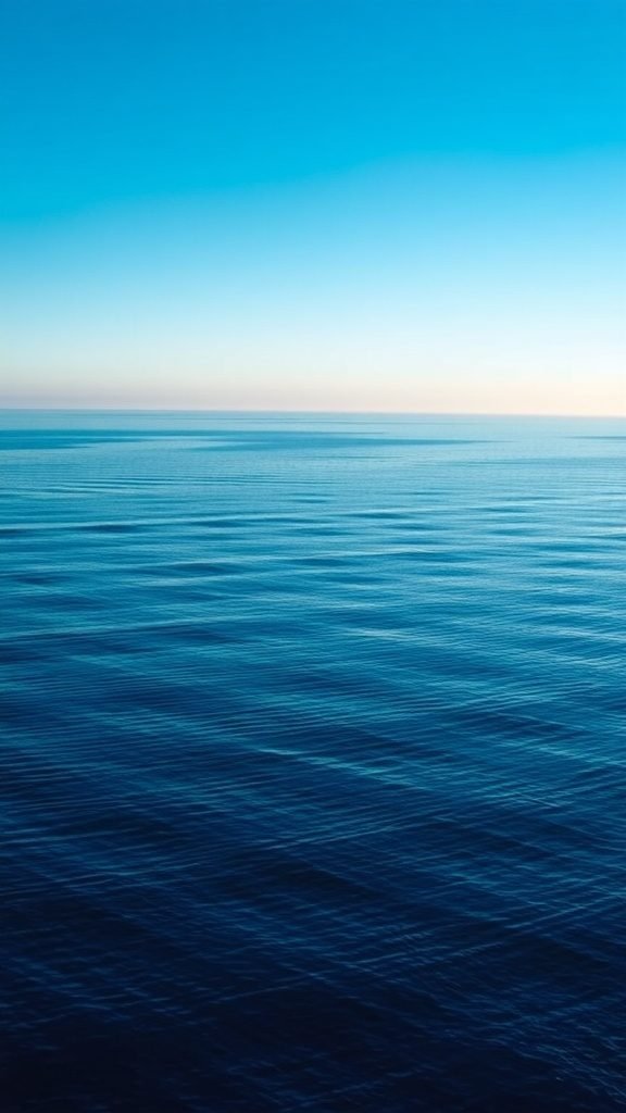 A serene horizon over a calm ocean with a gradient blue sky. May Phone Wallpaper