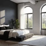 A luxurious modern monochrome bedroom featuring a black platform bed with white linens and velvety pillows, shiplap walls, and a matte black accent wall, illuminated by natural sunlight through sheer curtains, showcasing layered textures and a potted fiddle leaf fig.