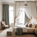 A luxurious small bedroom featuring a dramatic white canopy bed, custom storage, floating brass nightstands, and a large arched mirror, all bathed in warm morning light.
