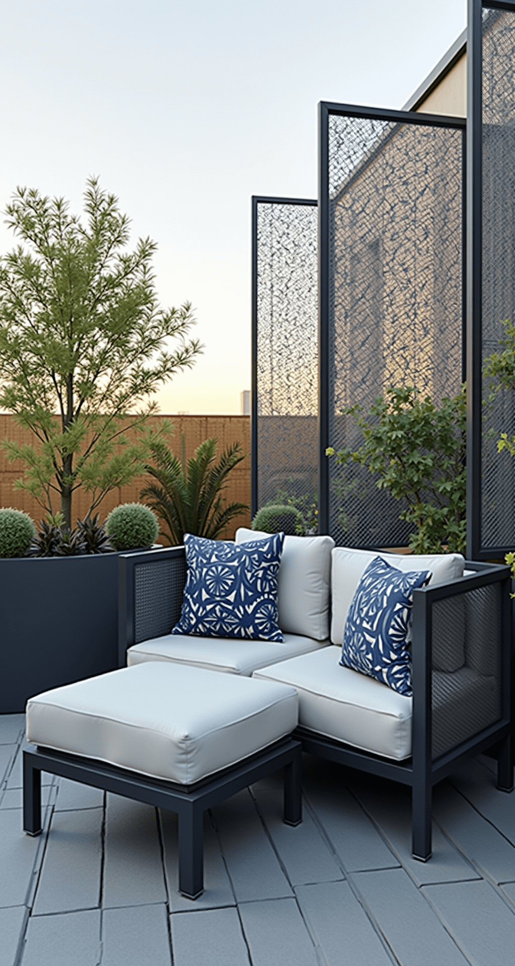 A stylish modern rooftop patio featuring a multifunctional ottoman with hidden storage, sleek graphite steel and mesh furniture, geometric privacy screens, and drought-resistant plants in fiberglass planters, all captured in mid-morning light.