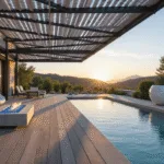 Photorealistic image of a modern luxury poolside pergola with a sleek black aluminum frame and retractable white canvas, featuring suspended white egg chairs, a low concrete fire pit with blue glass crystals, and an infinity pool reflecting the sky, all captured in soft golden hour lighting with hyper-detailed water ripples and a sophisticated outdoor furniture arrangement.