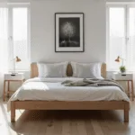 A serene Scandinavian bedroom featuring a light oak platform bed with white linens and gray throw pillows, illuminated by soft morning sunlight filtering through sheer curtains, with minimalist decor and natural textures, captured in a hyperrealistic wide-angle shot.