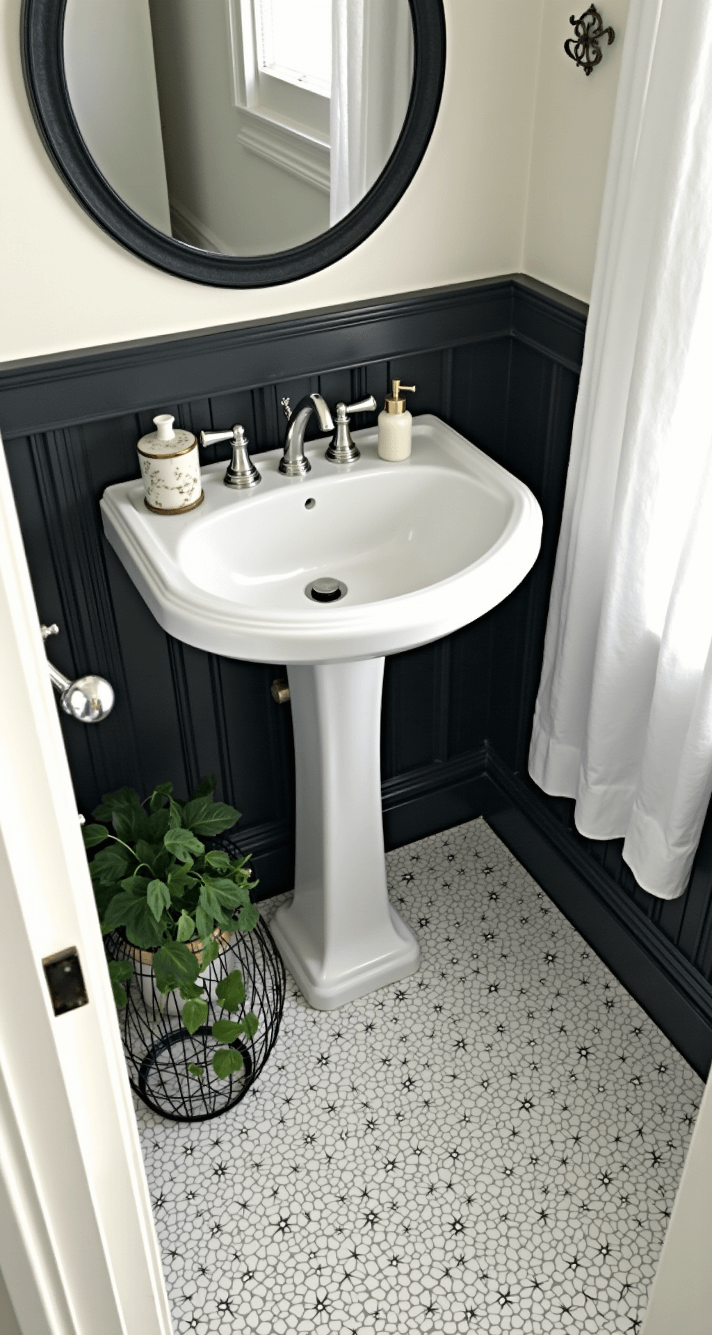 Designing a Stunning Black and White Bathroom: Your Ultimate Guide Overhead view of a compact 5x7ft bathroom featuring a white pedestal sink with a round black-framed mirror, classic black and white penny tile flooring, and styled vignettes of black wire baskets, white ceramic accessories, and a pothos plant.
