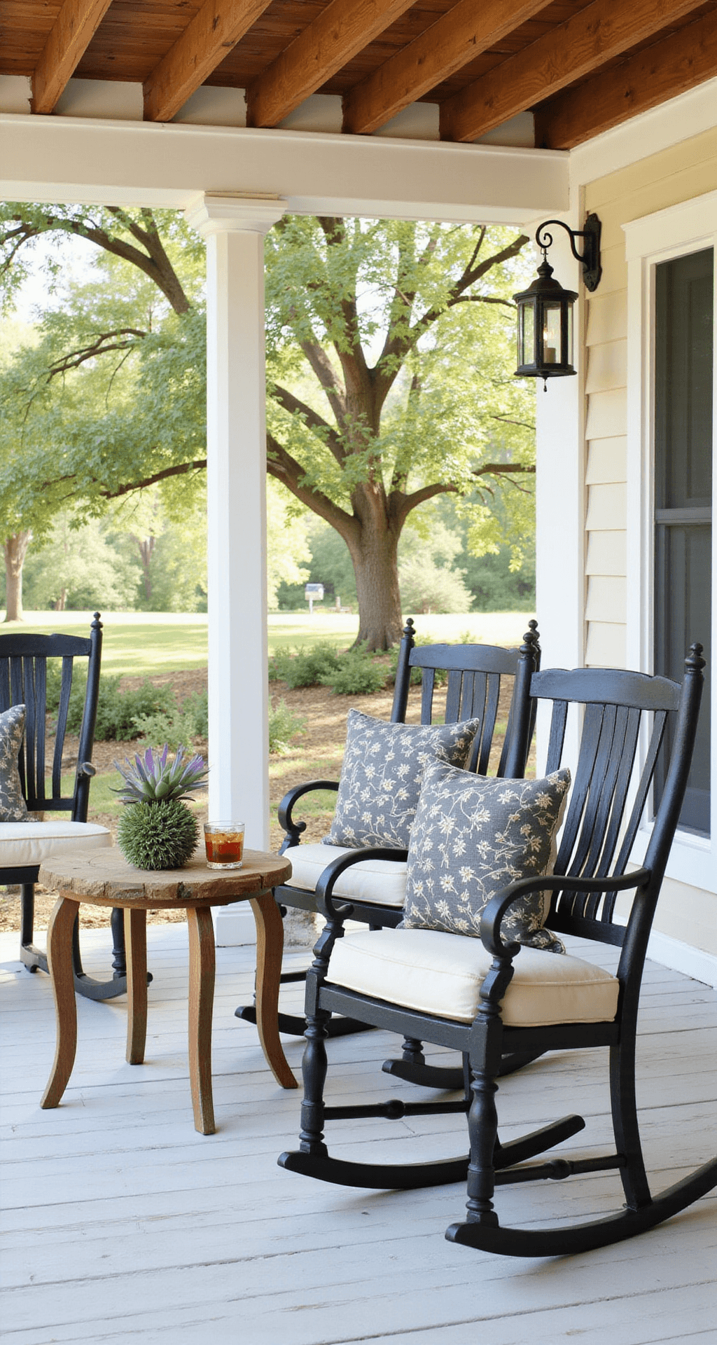 The Front Porch Chair That Made My Neighbors Stop and Stare (And How You Can Find Yours) A serene wraparound porch features elegant black metal rocking chairs with cream outdoor cushions, a rustic side table with iced tea and succulents, and dappled sunlight filtering through oak trees, creating a cozy outdoor sanctuary.